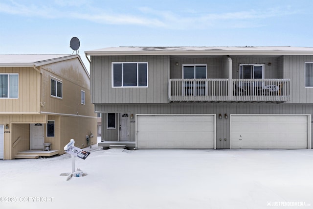 view of front of house with a garage and a balcony