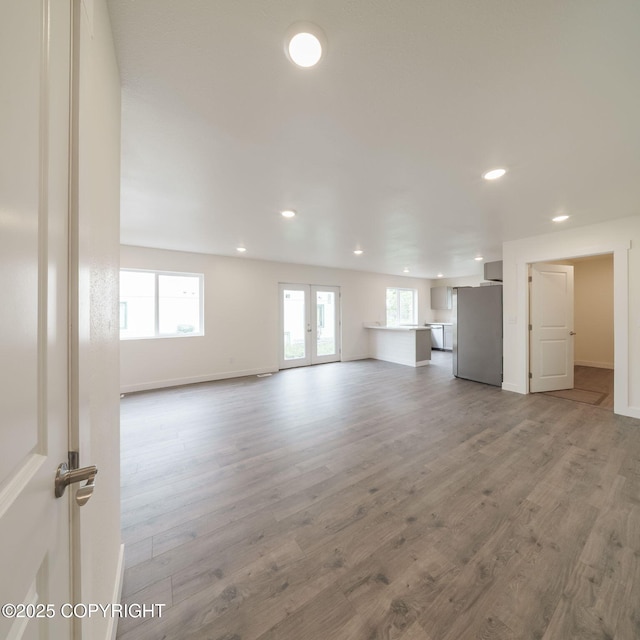 445 Idaho St, Anchorage, AK 99504 - unfurnished living room featuring recessed lighting, healthy amount of natural light, wood finished floors, and french doors