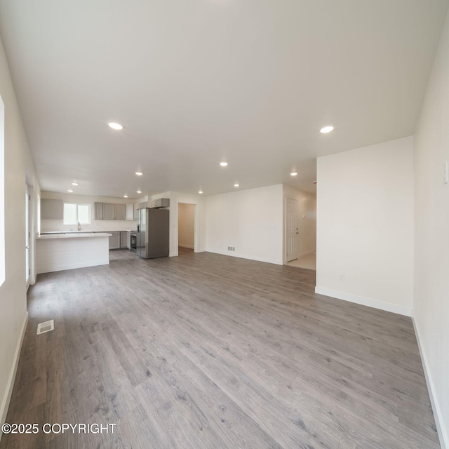 445 Idaho St, Anchorage, AK 99504 - unfurnished living room featuring recessed lighting and light wood finished floors