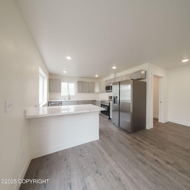 445 Idaho St, Anchorage, AK 99504 - kitchen featuring appliances with stainless steel finishes, recessed lighting, a peninsula, wood finished floors, and gray cabinets