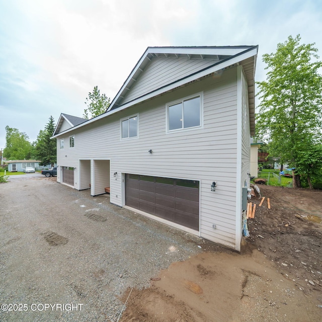 445 Idaho St, Anchorage, AK 99504 - view of property exterior featuring a garage and driveway