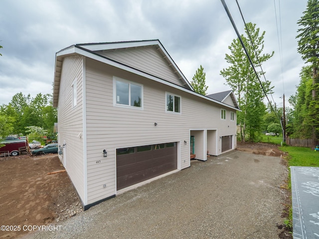 445 Idaho St, Anchorage, AK 99504 - view of front facade featuring an attached garage and asphalt driveway