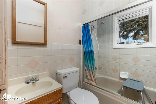 full bathroom featuring vanity, tile walls, shower / bath combo with shower curtain, and toilet