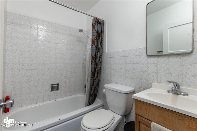 full bathroom with shower / bath combo with shower curtain, vanity, toilet, and tile walls