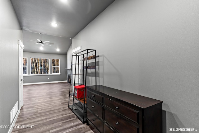 corridor featuring hardwood / wood-style flooring and lofted ceiling