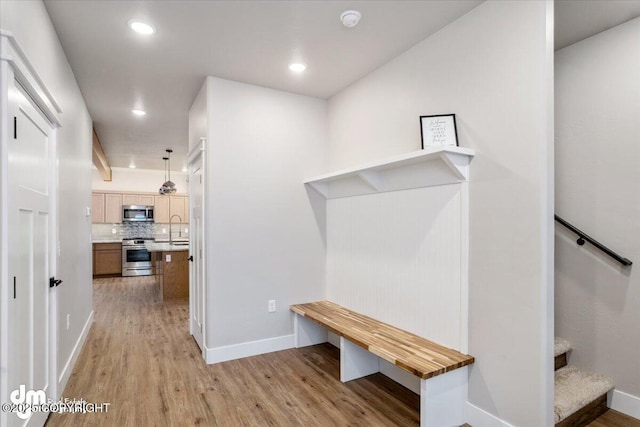 hall featuring sink and light hardwood / wood-style flooring