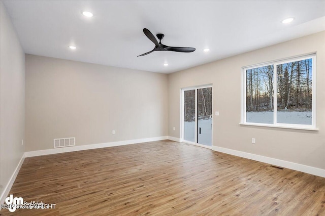 spare room featuring ceiling fan and light hardwood / wood-style flooring