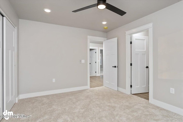 unfurnished bedroom featuring ceiling fan and light colored carpet