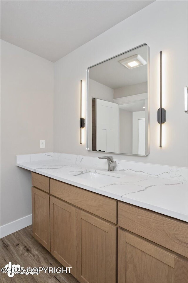 bathroom featuring hardwood / wood-style flooring and vanity