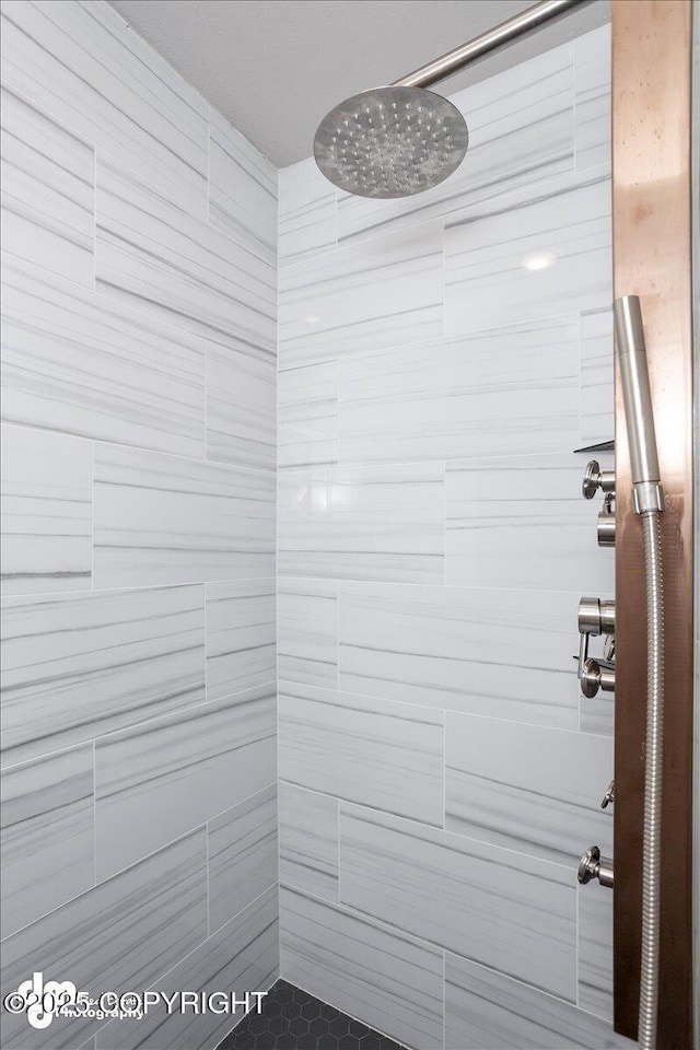 bathroom with tiled shower