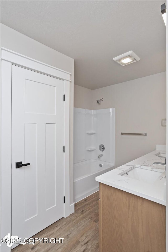 bathroom featuring shower / bath combination, vanity, and hardwood / wood-style floors