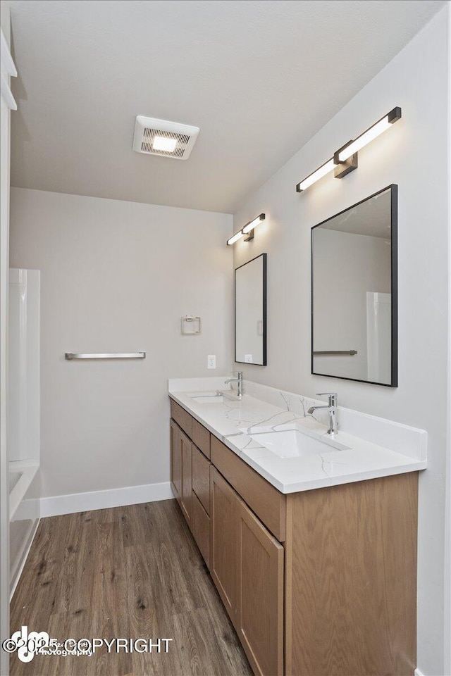 bathroom with vanity and hardwood / wood-style floors