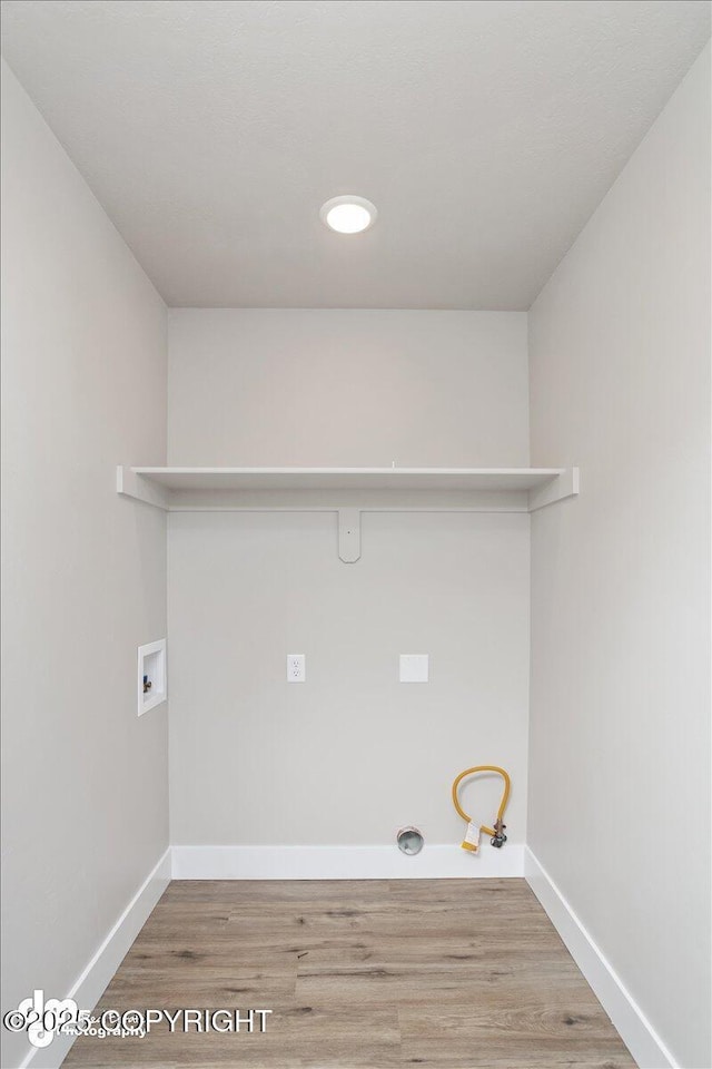 washroom with hookup for a gas dryer, hookup for a washing machine, and hardwood / wood-style flooring