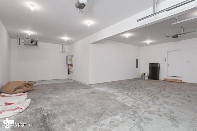 garage featuring water heater, a garage door opener, and electric panel