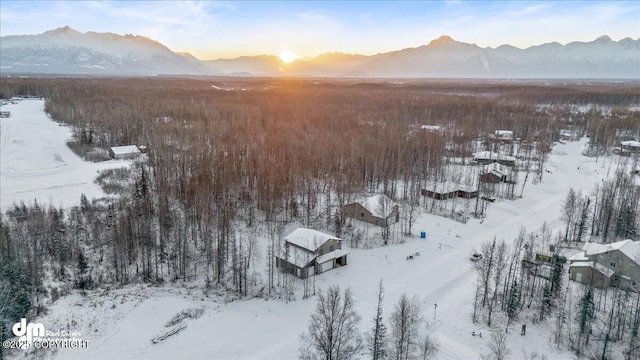 snowy aerial view with a mountain view