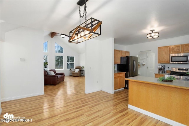 kitchen with vaulted ceiling with beams, light hardwood / wood-style flooring, pendant lighting, an inviting chandelier, and stainless steel appliances