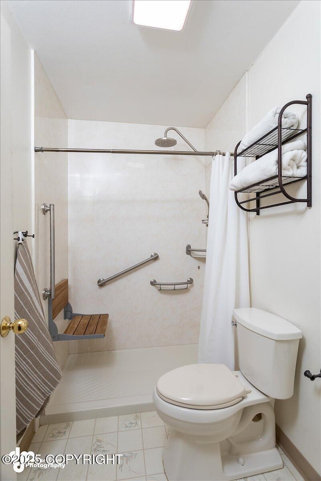 bathroom featuring curtained shower and toilet