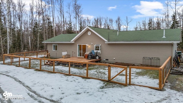 snow covered property with a deck