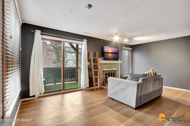 living room with wood-type flooring and a textured ceiling