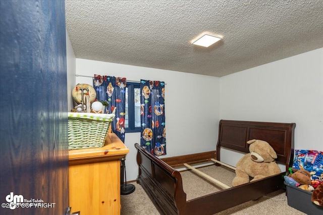 bedroom featuring light colored carpet and a textured ceiling