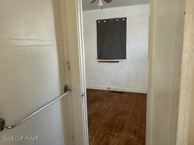 corridor with hardwood / wood-style flooring