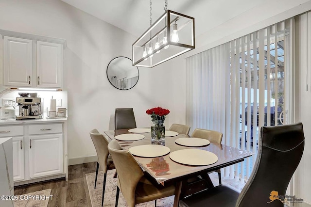 dining area with dark hardwood / wood-style flooring