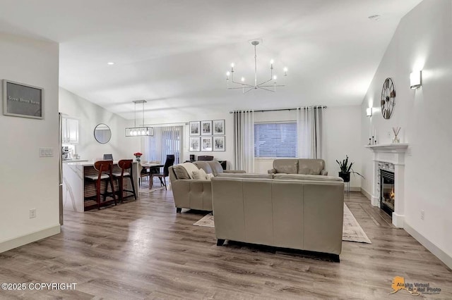 living room featuring an inviting chandelier and light hardwood / wood-style flooring