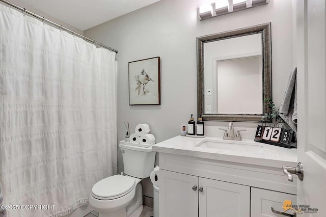 bathroom featuring toilet and vanity