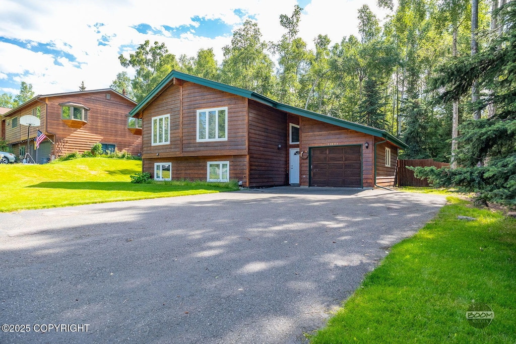 view of front of property with a garage and a front lawn