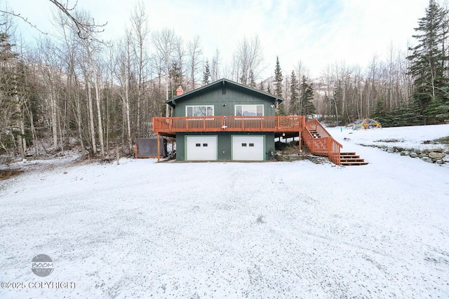 exterior space with a wooden deck and a garage