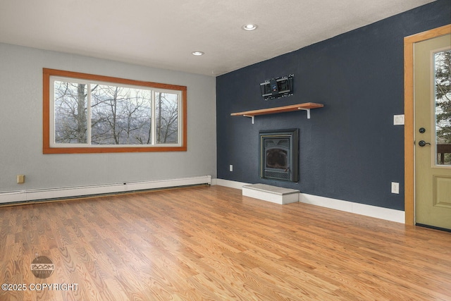 unfurnished living room with light wood-type flooring and baseboard heating