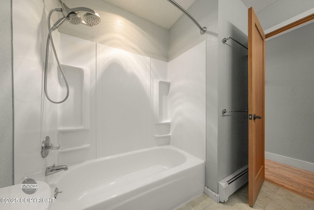 bathroom featuring tile patterned floors, shower / tub combination, and a baseboard radiator