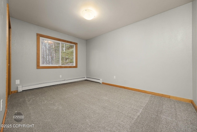 empty room featuring a baseboard heating unit and carpet flooring