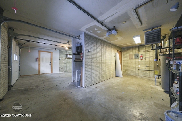 basement featuring brick wall and gas water heater