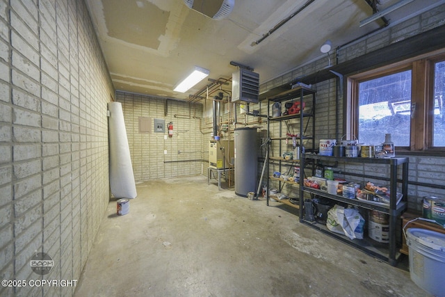 basement featuring brick wall and water heater