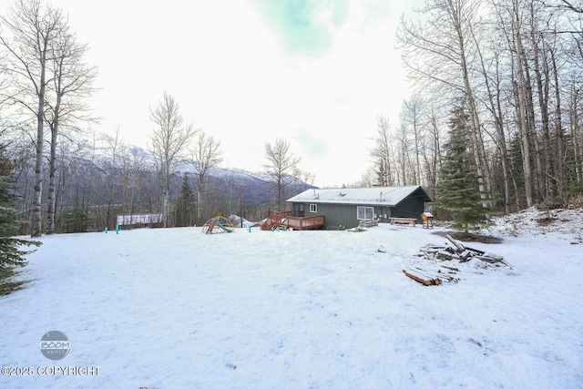 snowy yard with a wooden deck