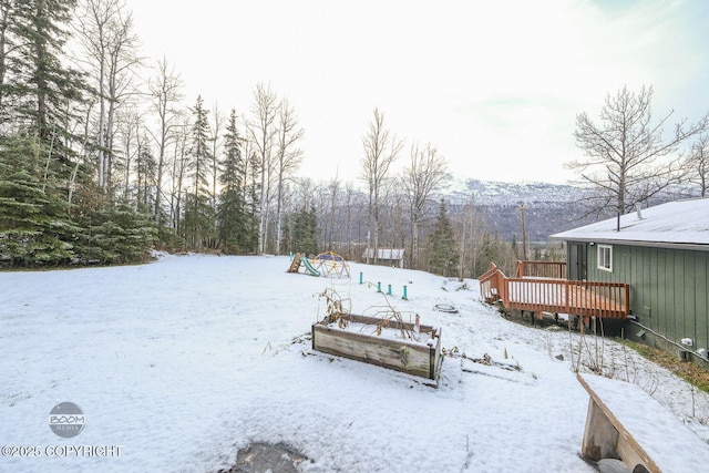 snowy yard featuring a wooden deck