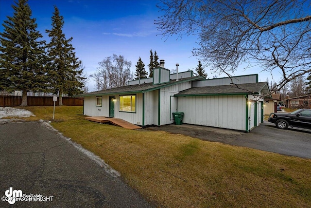 view of side of home featuring a lawn