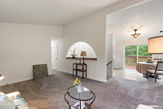 living room featuring carpet flooring and lofted ceiling