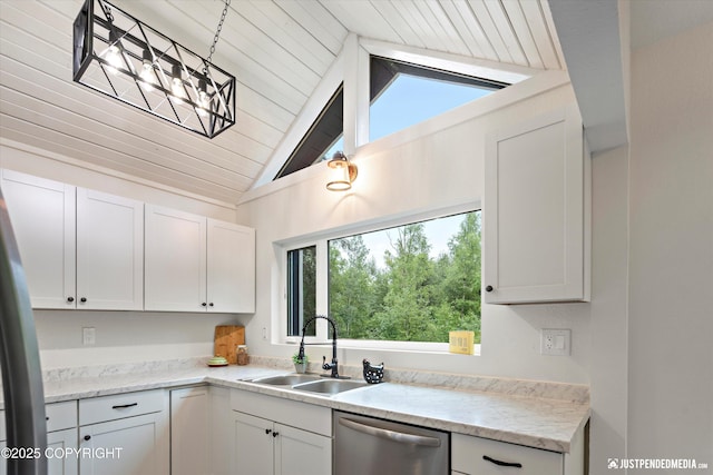 kitchen featuring decorative light fixtures, vaulted ceiling, dishwasher, sink, and white cabinets