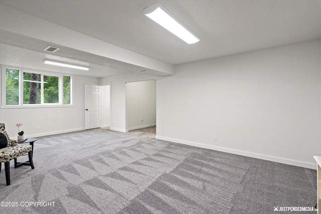 basement with carpet and a textured ceiling