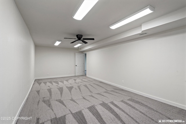 spare room featuring light carpet and ceiling fan