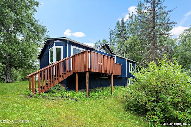 rear view of property with a deck and a yard