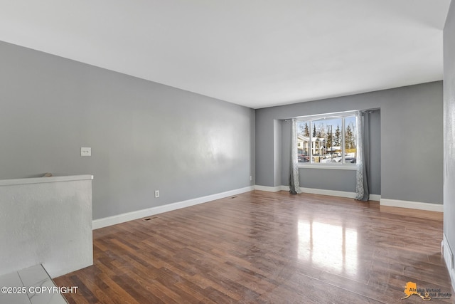 unfurnished room featuring dark hardwood / wood-style floors