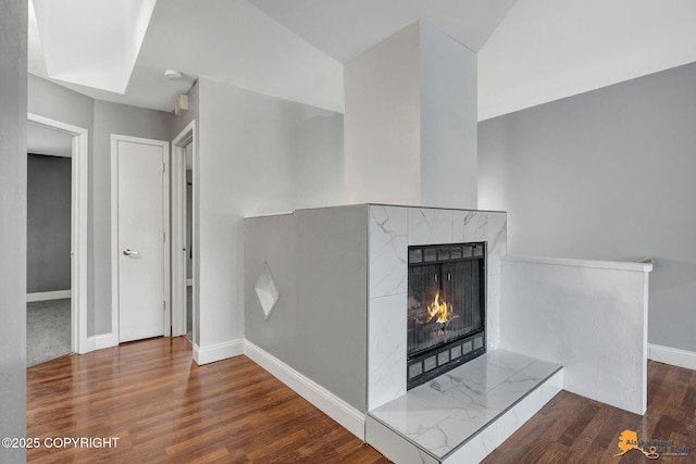 interior details featuring hardwood / wood-style flooring and a high end fireplace