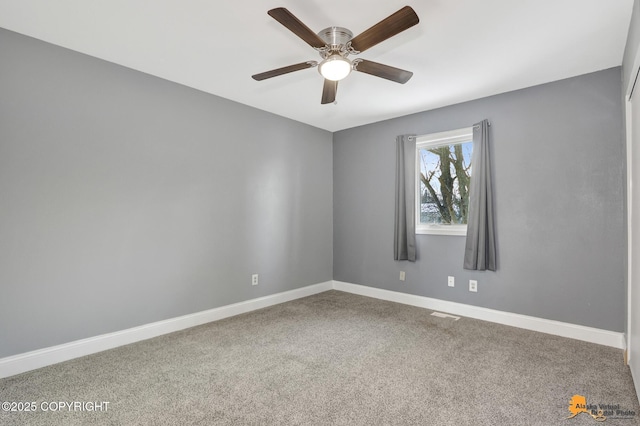 empty room with ceiling fan and carpet