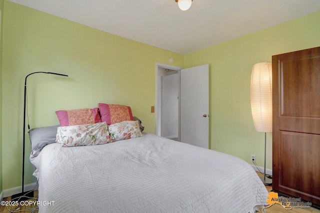 bedroom with baseboards and wood finished floors