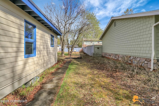 view of side of home featuring fence