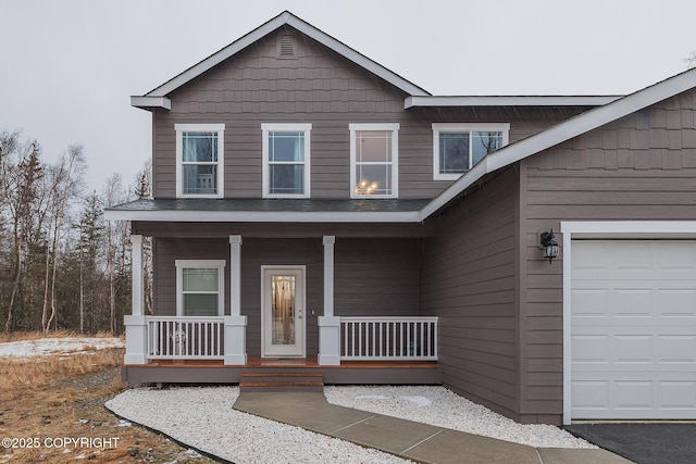 view of front facade featuring a garage and covered porch