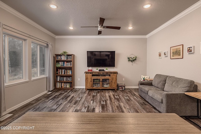 living room with ceiling fan, dark wood-type flooring, ornamental molding, and a textured ceiling